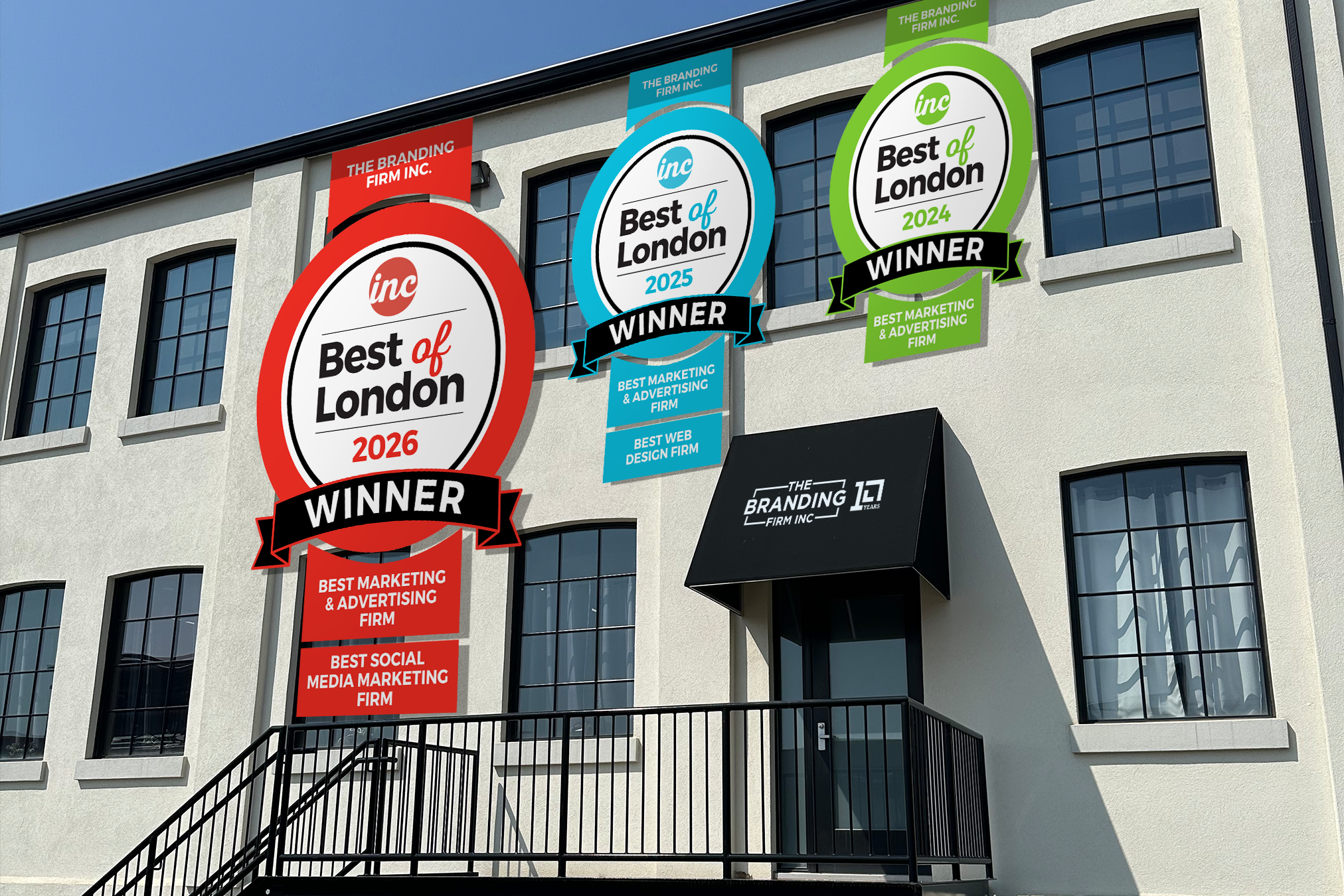 Office building with three large “Best of London” winner banners for 2024–2026, celebrating branding, advertising, and media marketing firms.